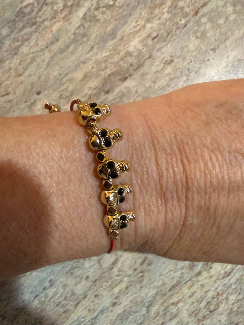 Gold-Tone Skull Bead Bracelet with Red Cord